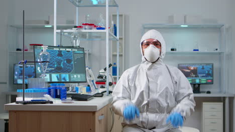 lab technician in ppe suit working with virtual reality