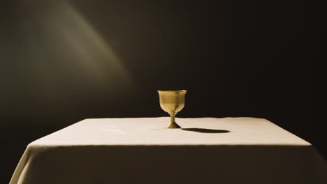 religious concept shot with chalice on altar in pool of light 1