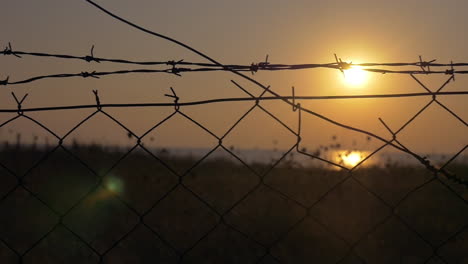 sunset behind the barbed wire