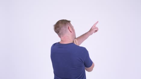 rear view of mature man with blond hair thinking