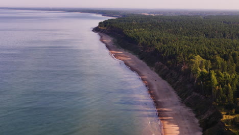4k aerial flyover revealing the wild, pristine, and beautiful baltic sea coastline of jurkalne; a popular beach destination in latvia.