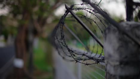 Fence with wires at a gate. Bokeh background and focused at the wires.