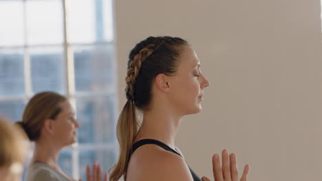 yoga-class-of-healthy-pregnant-women-practicing-prayer-pose-meditation-enjoying-mindfulness-exercise-in-studio-at-sunrise