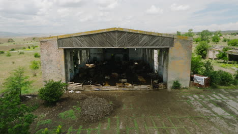 Soviet-Abandoned-Airfield-Building,-Backwards-Aerial