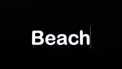 typing on a dark background with the word beach