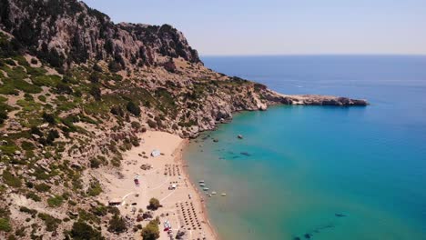 tsambika beach and rocky headland on the mediterranean coast in rhodes island, greece