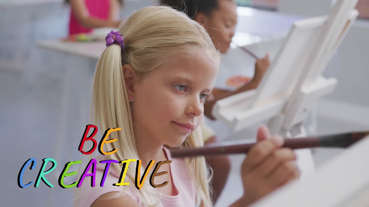 Animation of be creative text in multi colours over happy caucasian schoolgirl painting in art class
