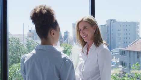 Two-women-talking-near-the-window