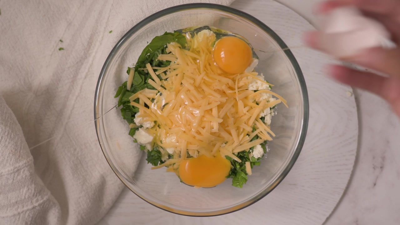 Cracking Eggs into a Bowl of Ingredients