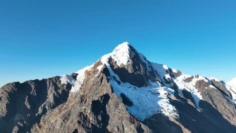 Flying-view-of-the-mountains,-snow-capped-La-Veronica,-Sacred-Valley,-Cusco