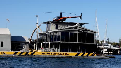 helicopter approaches and lands on floating helipad