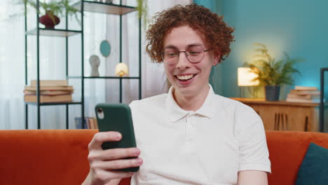 surprised excited man holding smartphone reading good news amazed by online game casino lottery win