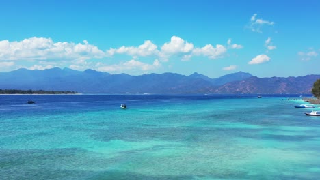 paradise tropical bay with shallow blue azure lagoon where many boats sailing and floating around tropical island full of resorts for vacation in indonesia