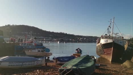 the river teign with fishing boats resting on the shoreline in teignmouth, devon, uk