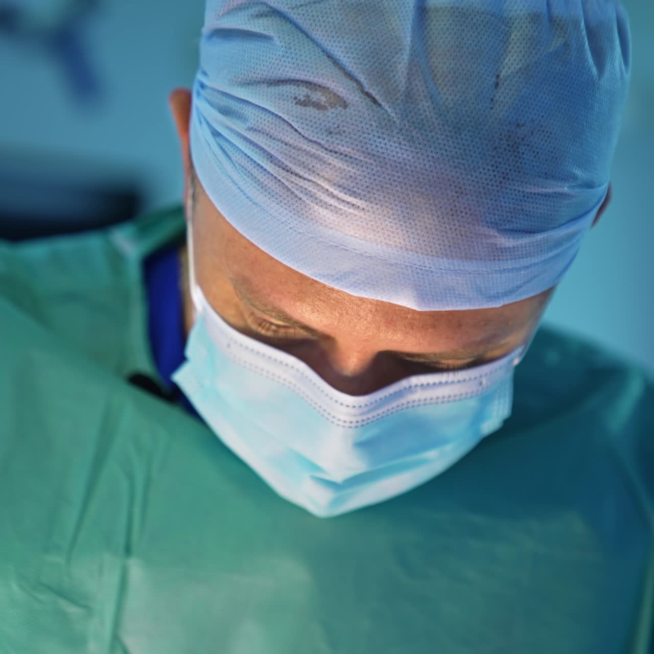 Portrait of plastic surgeon in mask. Face of a professional doctor man performing liposuction surgery in clinic. Close-up