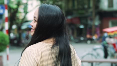 handheld view of beautiful vietnamese woman in the city street