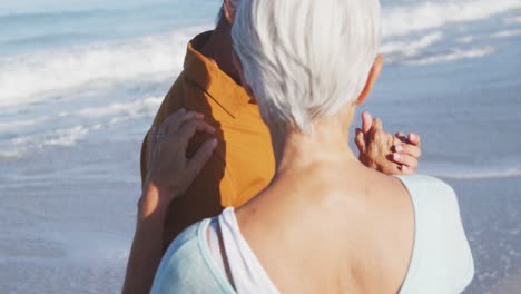 senior caucasian couple dancing at the beach