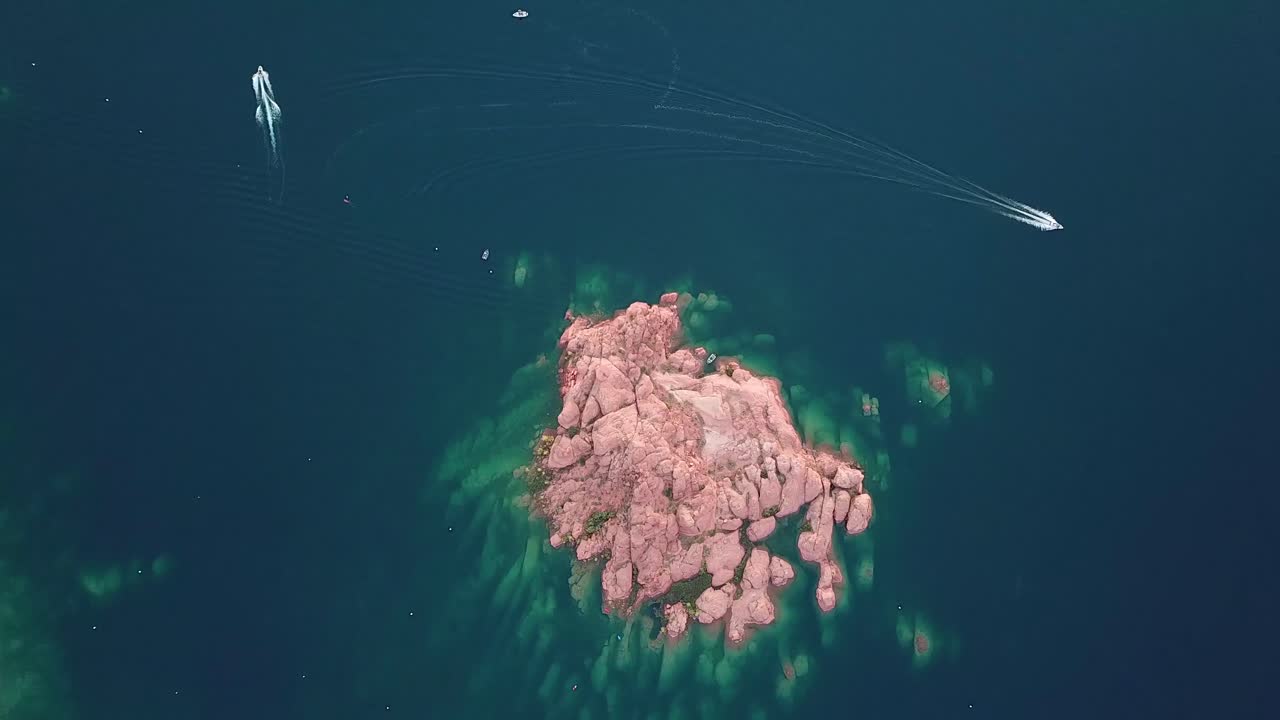 High Angle Aerial View of Red Rock Islet and Boat in Water Reservoir Lake in Sand Hollow State Park, Utah USA