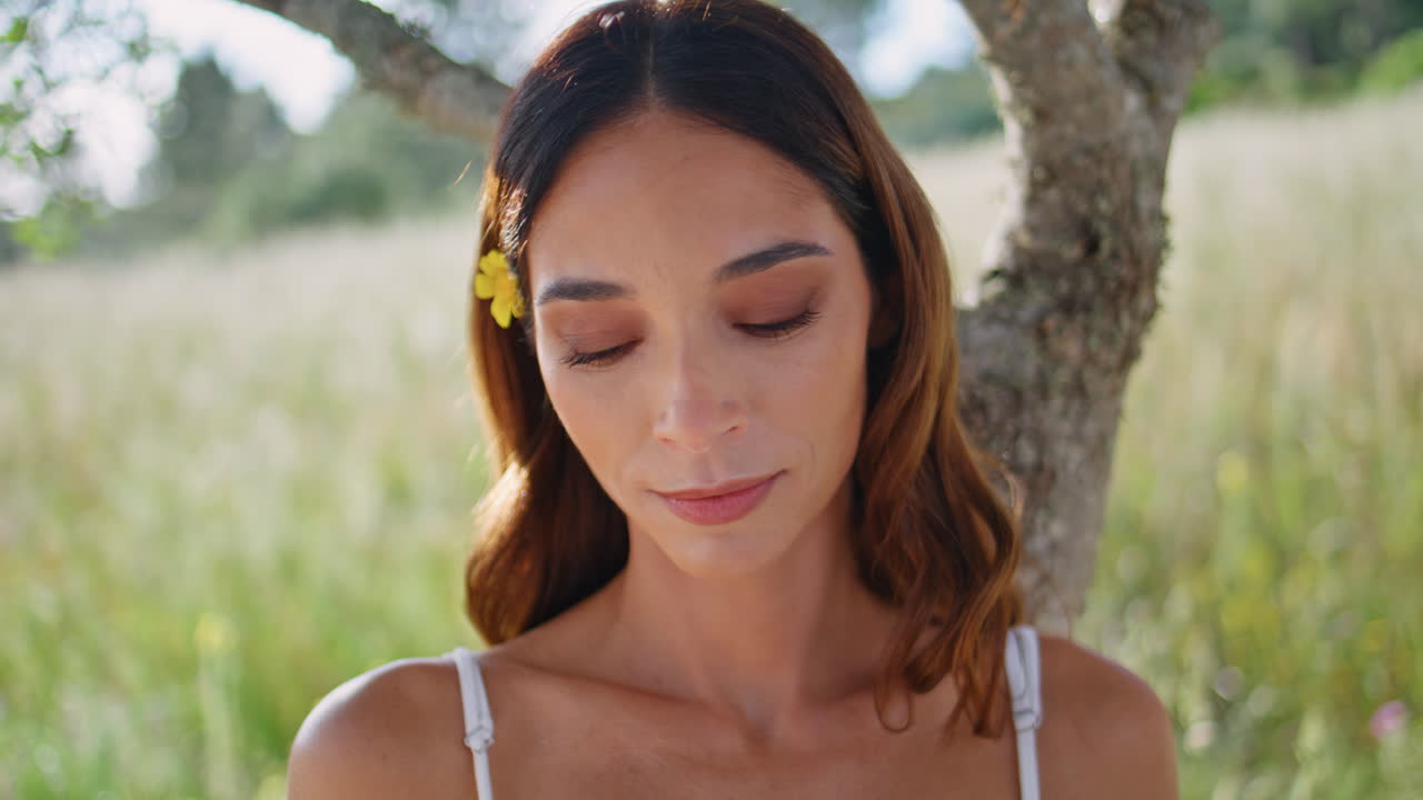 Thoughtful woman holding book at meadow portrait. Lady author looking distance