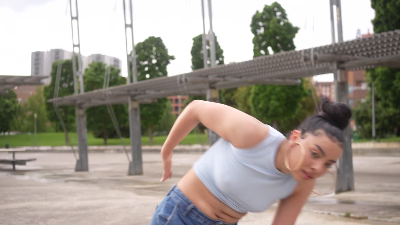 Woman dancing in an urban park