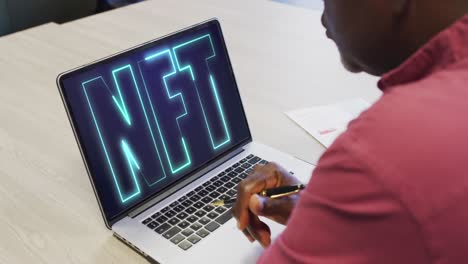 african american businessman using laptop for video call with nft text