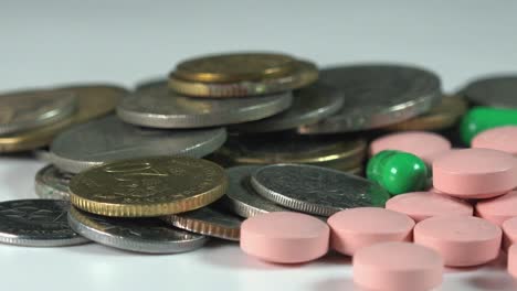 Close-Shot-of-Coins-and-Pills