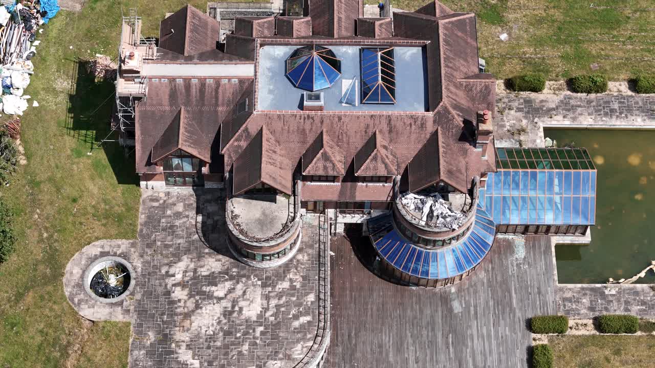 Neglected luxurious millionaire property aerial Birdseye view above rundown private estate rooftop