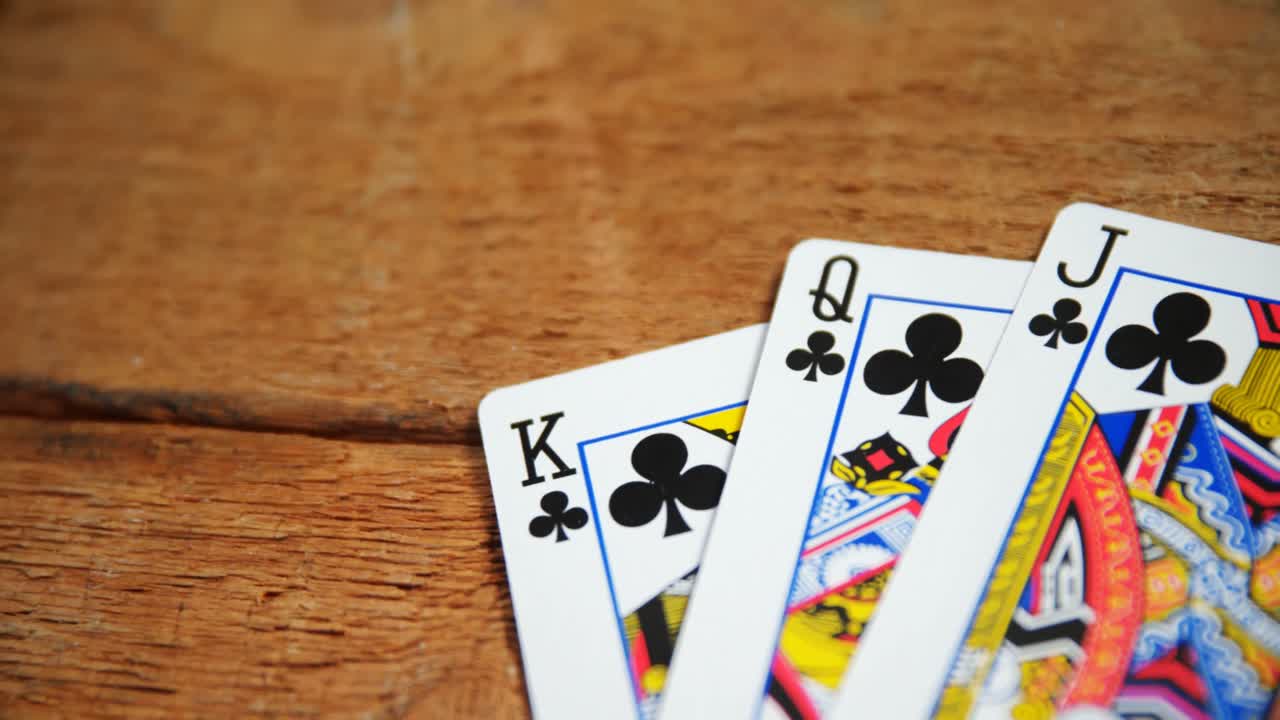 Playing cards on wooden table 4k