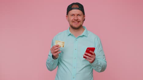 man using credit bank card and smartphone while transferring money purchases online shopping