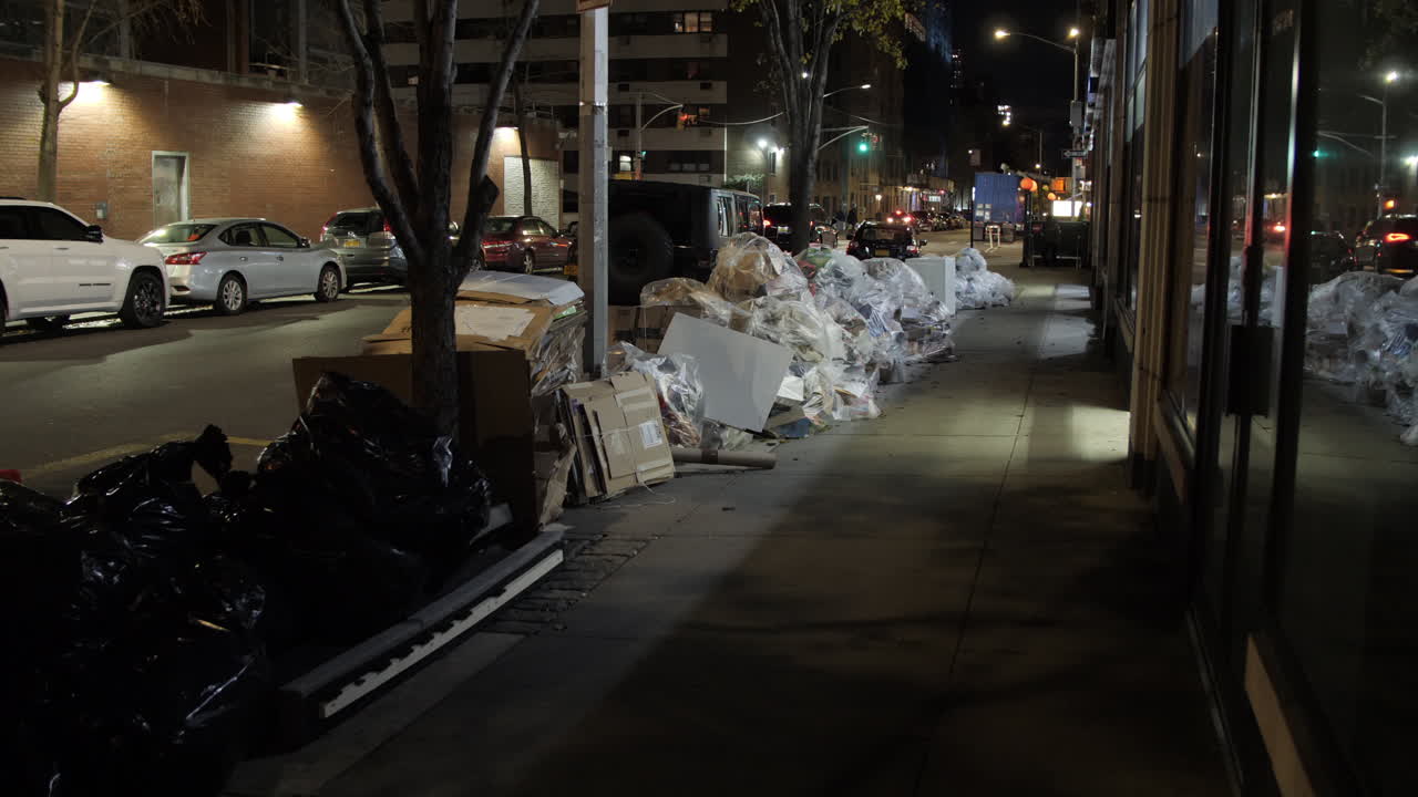 Wide panning shot of bags of trash on a NYC sidewalk