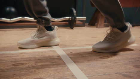 person jumping jacks in gym