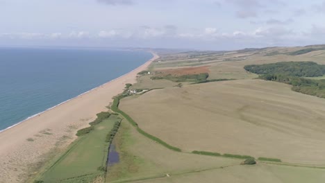 aerial tracking from right to left above the stunning chesil beach which stretches west along the coast