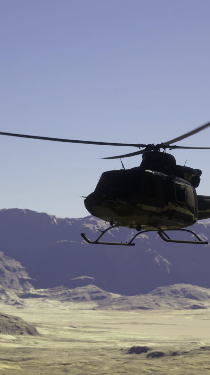 Helicopter flying over mountainous desert landscape during daylight
