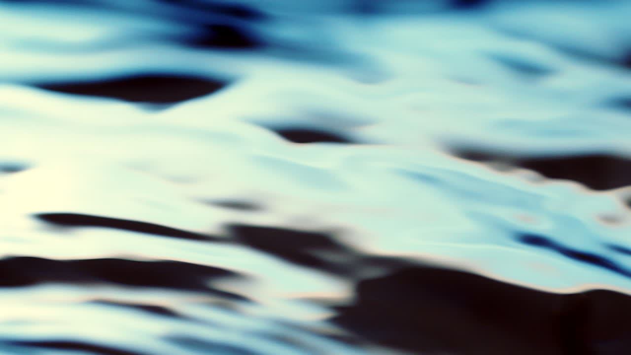 Water surface dark blue texture with clean ripples and wave refraction background. Slow motion