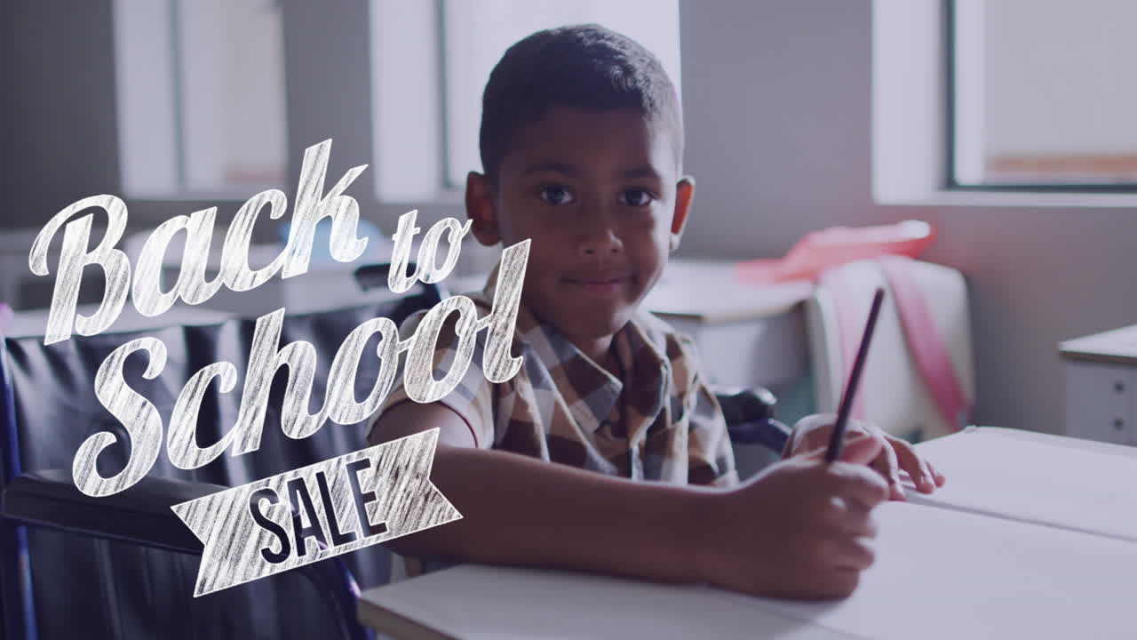 Animation of back to school sale text over smiling biracial schoolboy working at desk in class