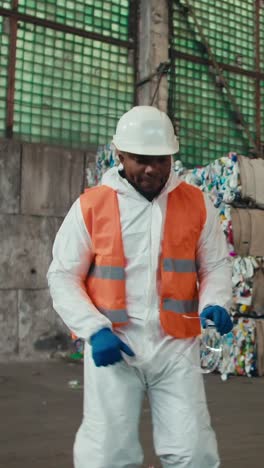 recycling worker dancing in a recycling facility