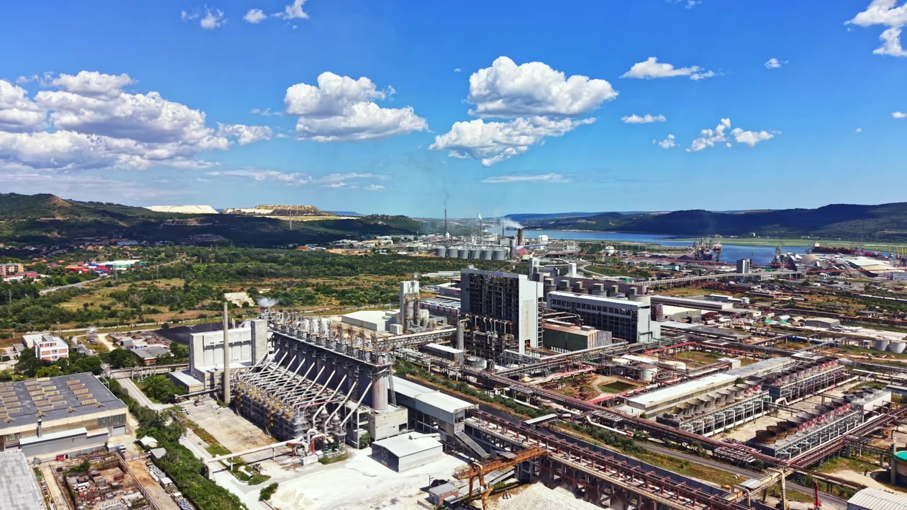 Complejo industrial cerca de río con fábricas y paisaje durante el día