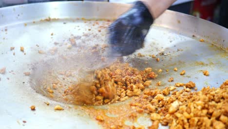 preparing chicken stir-fry on a large pan