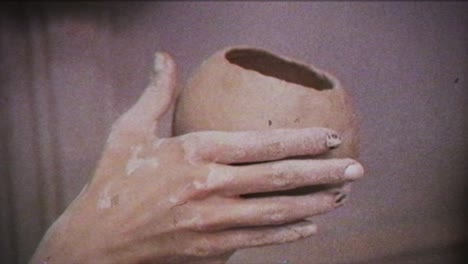 young woman makes a jug of clay. female hands mold pottery. vintage effect.