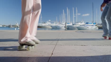 women roller skating at waterfront marina