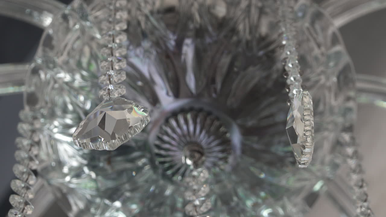 Close up of a crystal chandelier hanging on the ceiling