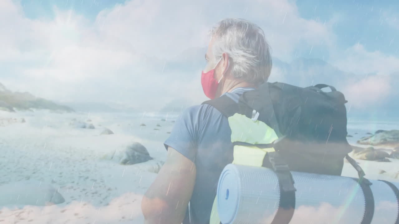 mature man walking along rocky beach, displaying floating weather charts and travel icons