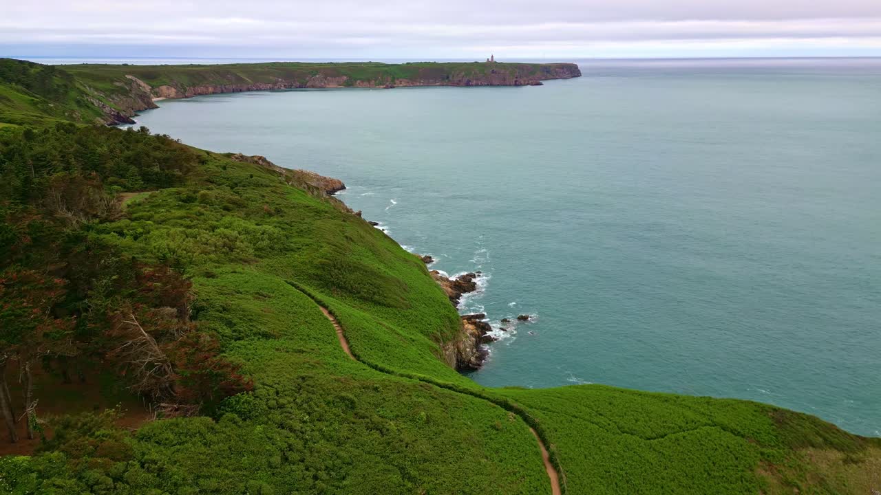 Backward drone movement over a dramatic green coastline closer to the Fort la Latte, Côte Bretonne, Brittany, France.