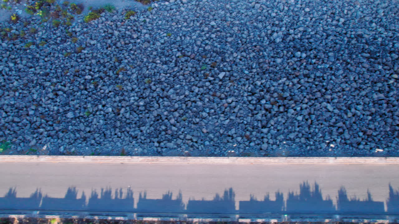 Road at the Barbate Reservoir, birdseye view tilting up to reveal the lake