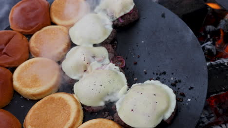 Close-up-flame-grilled-reindeer-cheese-burgers-sizzling-on-Swedish-barbecue