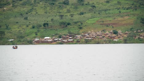 Eine-Totalaufnahme-Des-Victoriasees-Mit-Blick-Auf-Ein-Kleines,-Abgelegenes-Fischerdorf-Und-Ein-Fischerboot-In-Der-Ferne