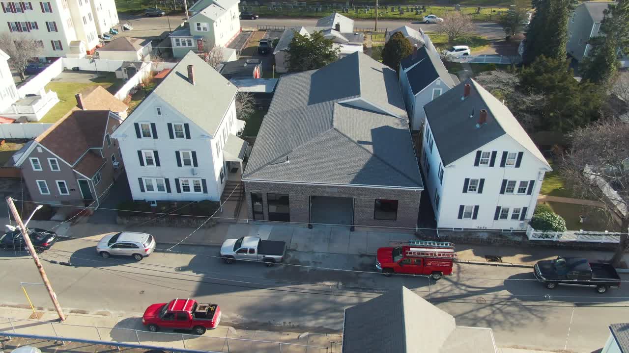 Zoom away from house in Peabody, Massachusetts neighborhood toward blue sky horizon