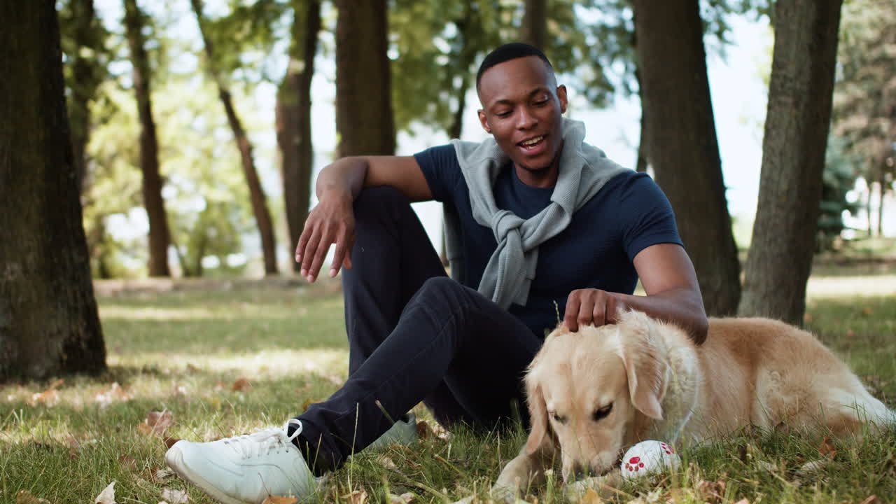 Black man with dog at the park