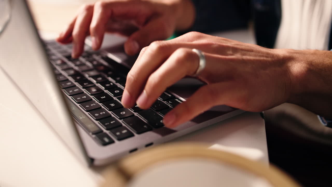 Close Up of Hands Typing on Laptop Keyboard