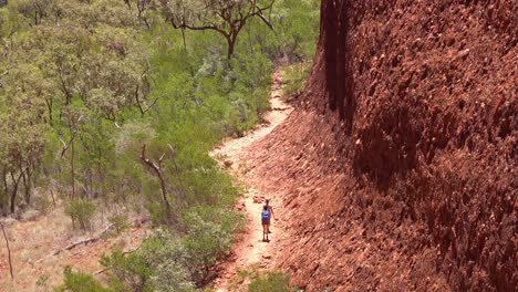 hikers walk through kata tjuta national park in australia